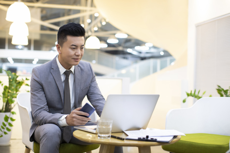 Businessman using laptop in office.jpg